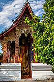 Luang Prabang, Laos - Wat Sene, a standing Buddha statue is housed inside an open pavilion.